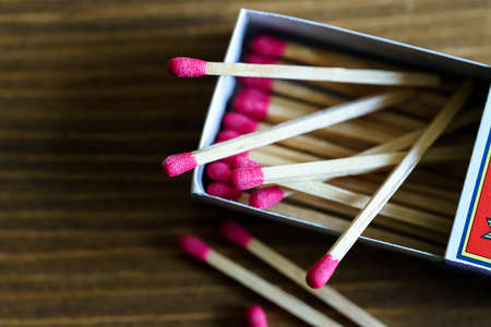 Matchbox and matches isolated on wooden tableの写真素材