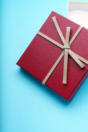 Gift box with ribbon on color background