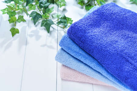 Stack of clean towels on wooden table