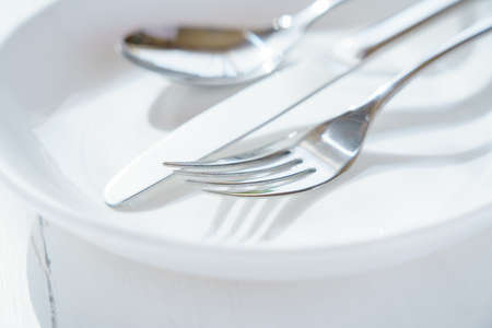 Empty plate, knife and fork