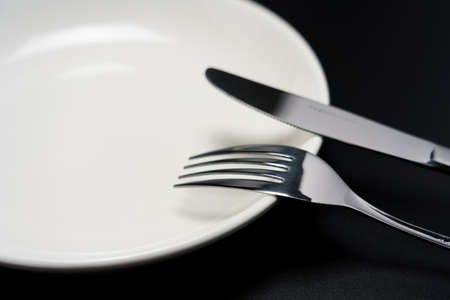 Empty plate, knife and forkの写真素材