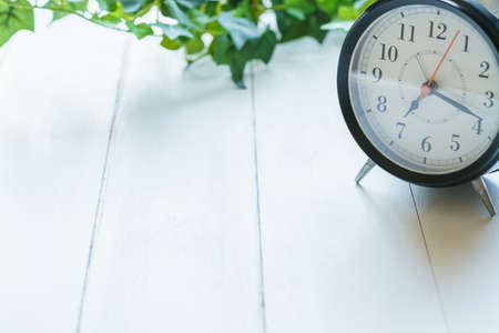 Alarm clock isolated on wooden table