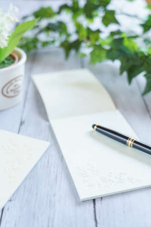 Memo pad and pen on wooden table