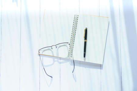 Notebook and pen on wooden table
