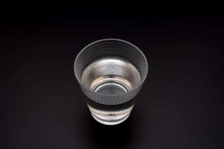 Glass of water isolated on dark background