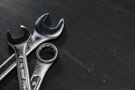 Set of spanners and wrenches on dark background