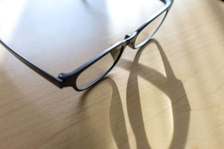 Eyeglasses on wooden tableの写真素材