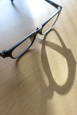 Eyeglasses on wooden tableの写真素材