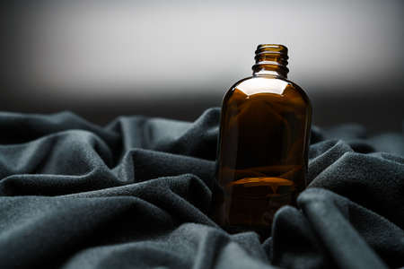 Brown medicine bottle on dark backgroundの写真素材