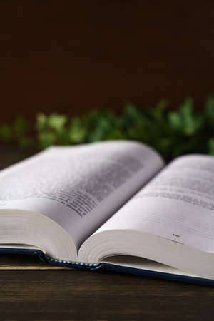 Hardback book on wooden tableの写真素材