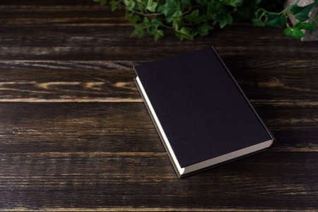 Hardback book on wooden tableの写真素材