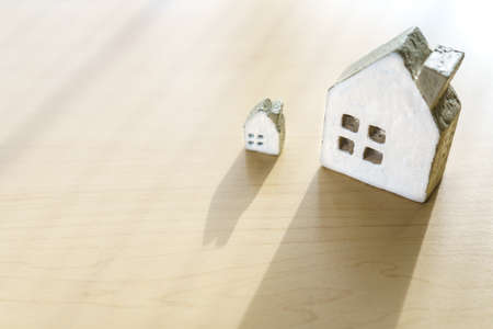 Miniature house on wooden background