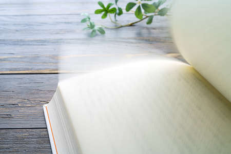 Hardback book on wooden background