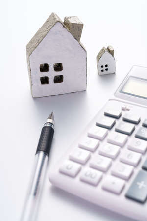 Calculator and miniature houseの写真素材