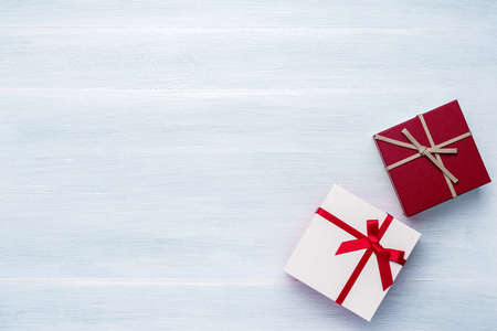 Gift box with ribbon on wooden table