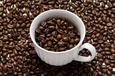 Coffee beans background with cupの写真素材