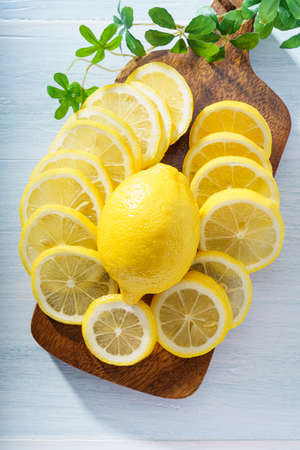 Sliced lemon fruit isolated on wooden tableの写真素材