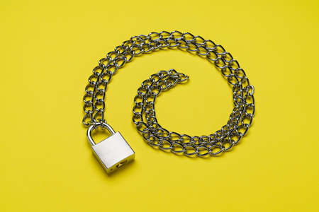 Padlock and chain on color backgroundの写真素材