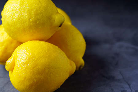 Fresh lemon fruit isolated on dark backgroundの写真素材