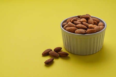 Almonds nuts shot on a color backgroundの写真素材