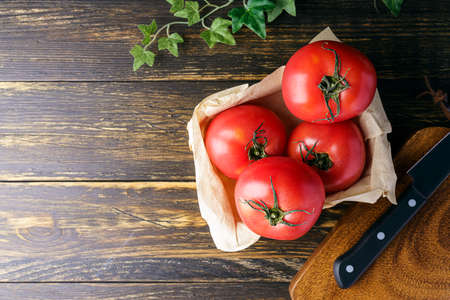 Fresh tomatoes isolated on wooden tableの写真素材