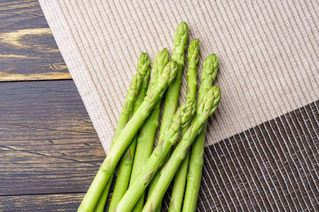 Green asparagus isolated on wooden tableの写真素材