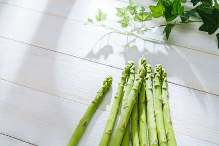 Green asparagus isolated on wooden table