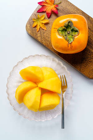 Fresh ripe persimmons on white backgroundの写真素材