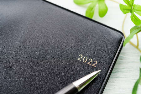 2022 Notebook and pen on wooden table (2022 schedule book)