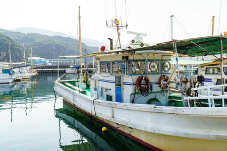Traditional fishing boats in Japanese harborの写真素材