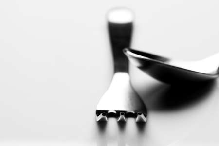 Fork and spoon on white background