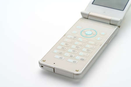 Flip cell mobile cell phone on white backgroundの写真素材