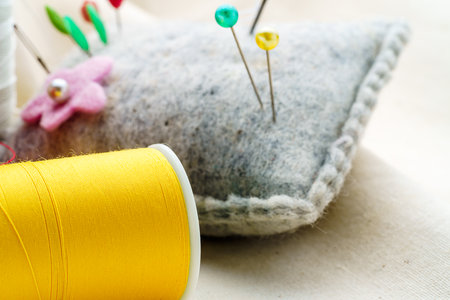 Close up sewing accessories on light backgroundの写真素材