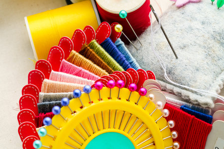 Close up sewing accessories on light background
