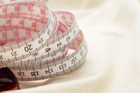 White measuring tape on wooden table