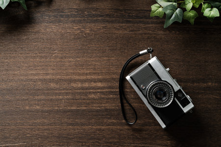 Old film cameras isolated on wooden tableの写真素材