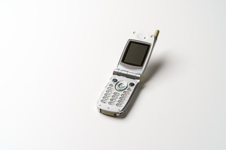 Old used cell phone on white backgroundの写真素材