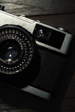 Old film camera isolated on dark background