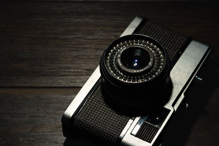 Old film camera isolated on dark background