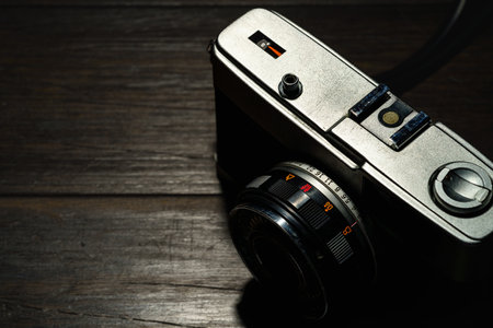 Old film camera isolated on dark backgroundの写真素材