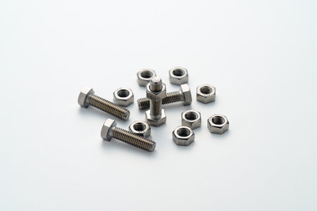 Steel nuts and bolts closeup on white background