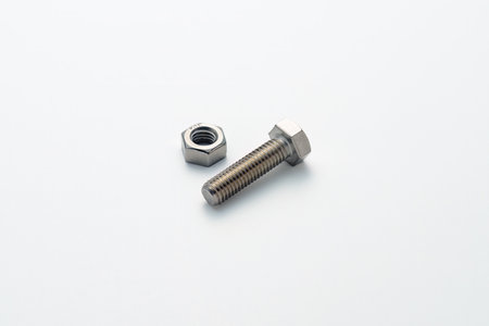 Steel nuts and bolts closeup on white background