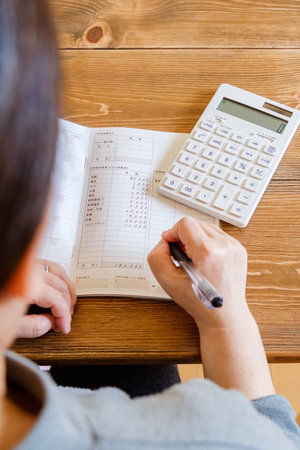 Household accounts book and saving money. Calculating personal finance.の写真素材