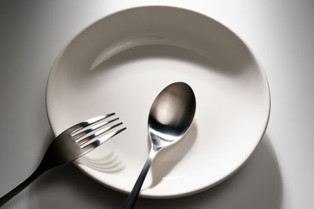 Fork and spoon on white background