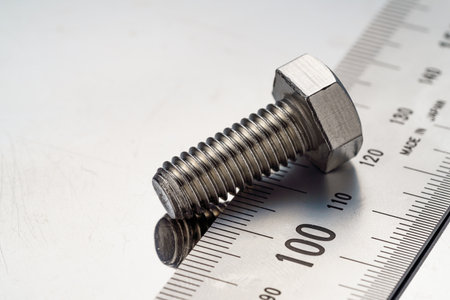 Steel bolt closeup on metal plateの写真素材