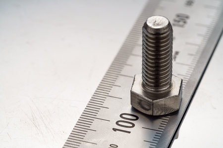 Steel bolt closeup on metal plateの写真素材
