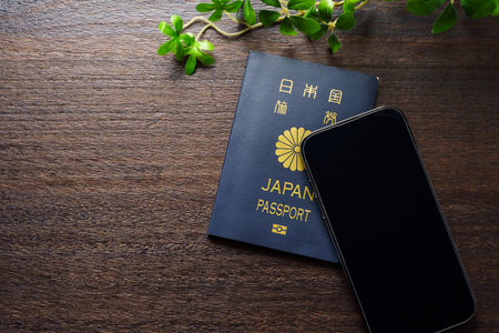 Japanese passport and smart phone on wooden table