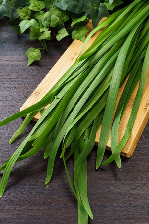 Garlic chive (chinese chive) on wooden table