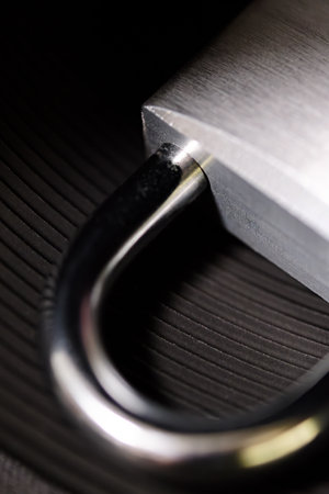 Padlock isolated on dark backgroundの写真素材