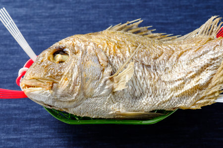 Whole grilled sea bream with saltの写真素材